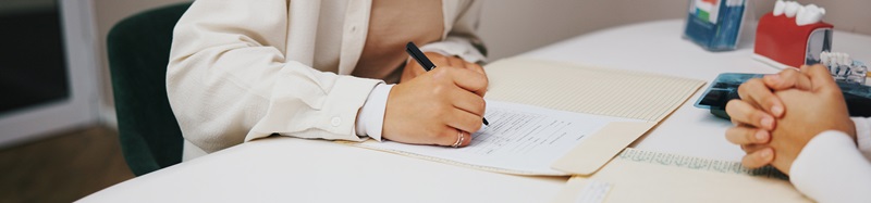 Hands, medical or writing with doctor and patient in hospital for appointment