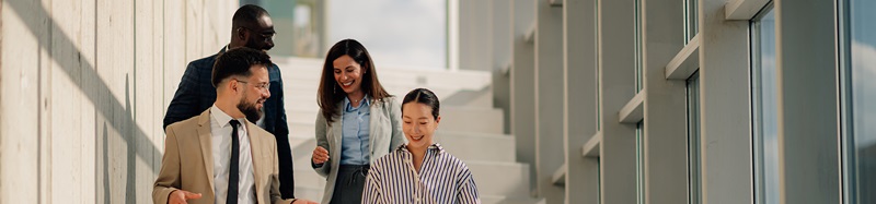 Business people walking down stairs in modern office building