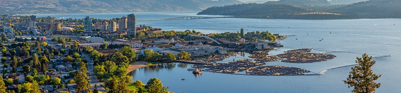 Kelowna British Columbia skyline and Okanagan Lake with the R W Bennett Bridge from Knox Mountain at sunset