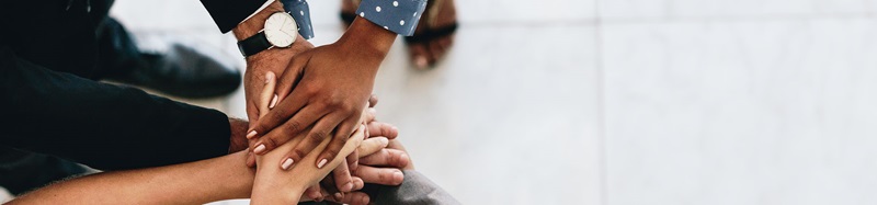 Group with hands stacked